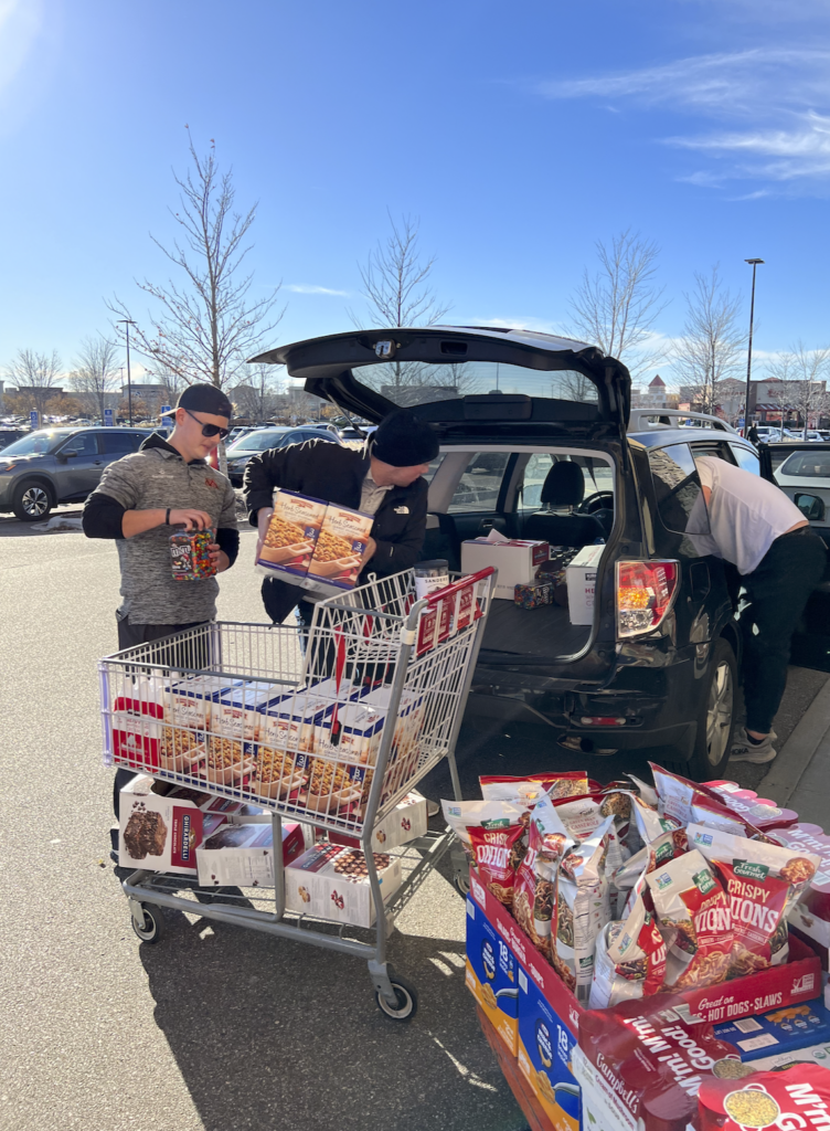 Everlight Solar staff fills cars with food to donate.